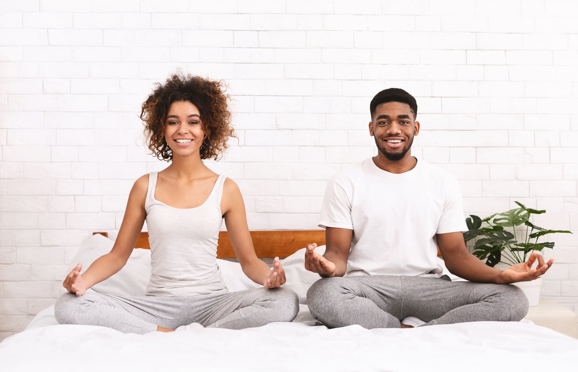 Couple Meditating in Bed 